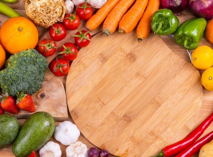 Discover a vibrant assortment of fresh fruits and vegetables arranged on a wooden board. Perfect for healthy eating inspiration.